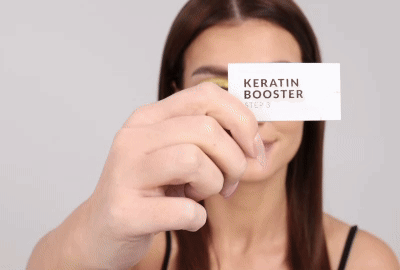 Model applying Step 3 - Keratin Booster on lashes