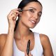 Smiling model applying the mascara