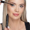 Blonde woman aplying the mascara to her lashes